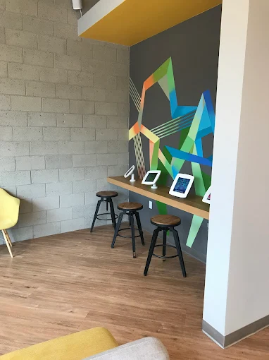 Hallway at TruSmile Orthodontics in Long Beach, showing sleek floors and doors leading to patient rooms